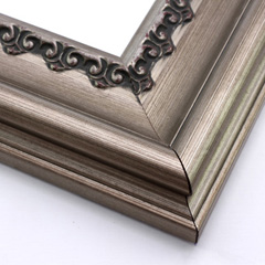 This steep, solid wood frame features a crown moulding profile in a bold, bronze-brushed silver.  The slight distressing on the deeply scooped face and the faint red patina on the delicate inner design give it an antique look that suits old paintings, prints and family photographs alike.

3.5 " width and 2 " high at outer edge: ideal for large and oversize images.